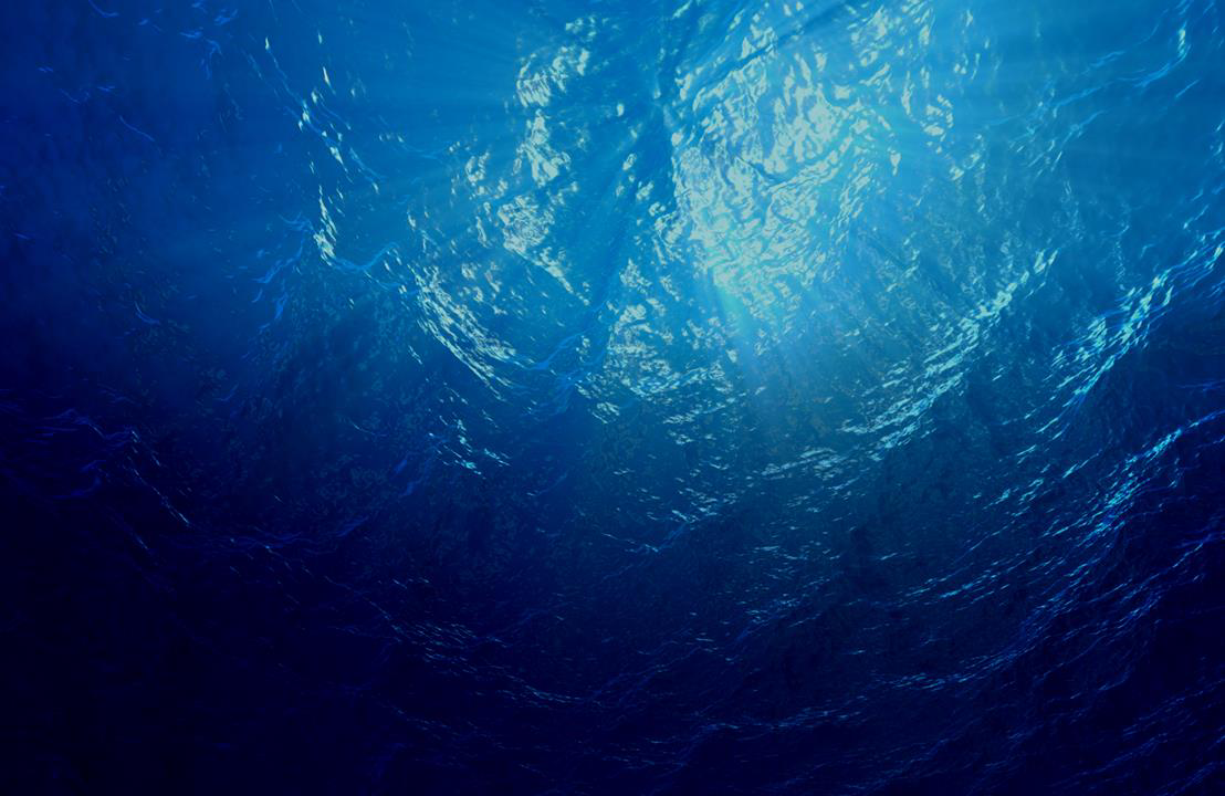 Underwater view looking up at sunlight through water